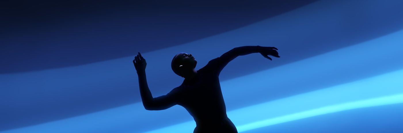 A dancer silhouetted in blue light wearing AirPods 5