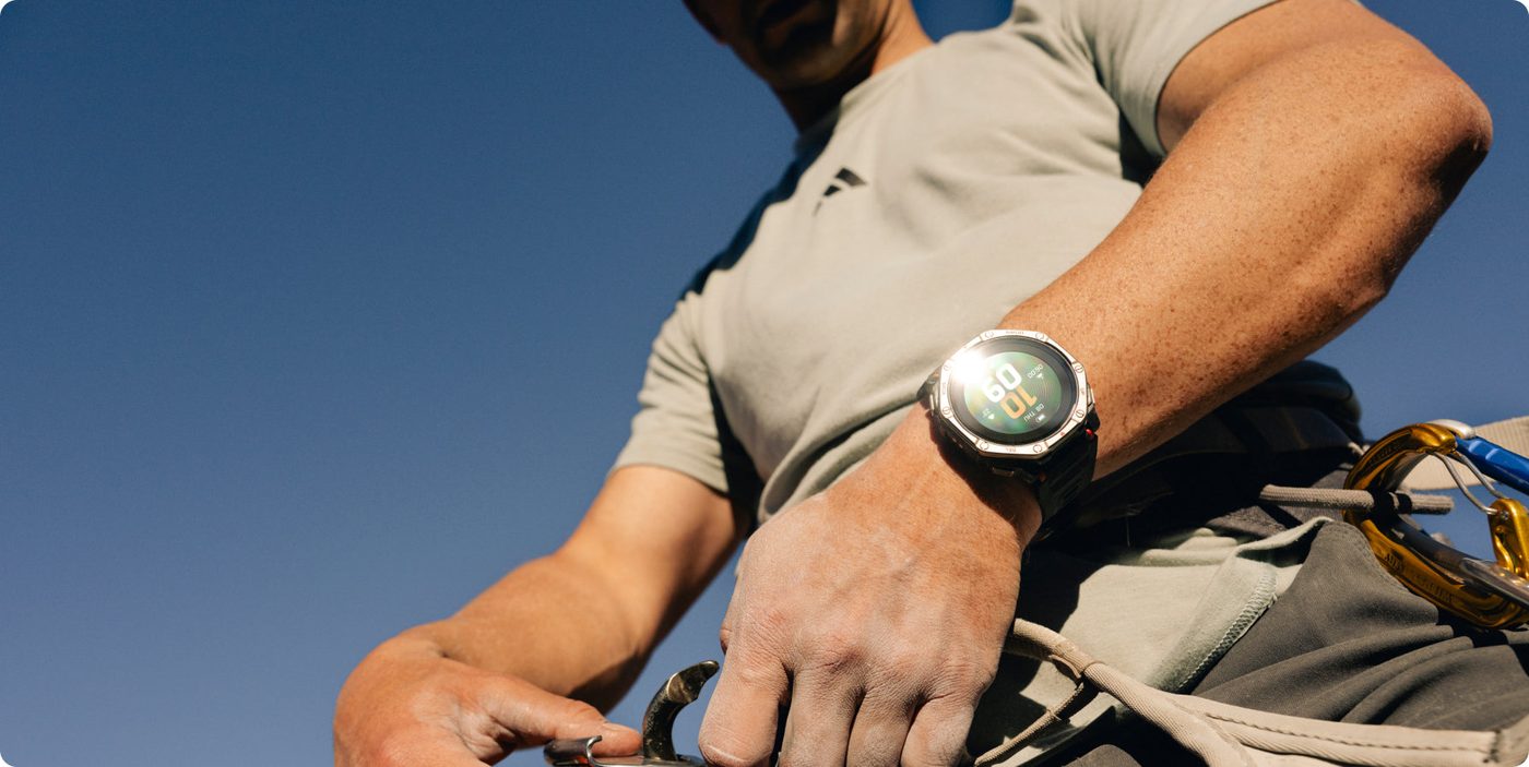 Climber wearing the Amazfit T-Rex Dual Solar in bright sun