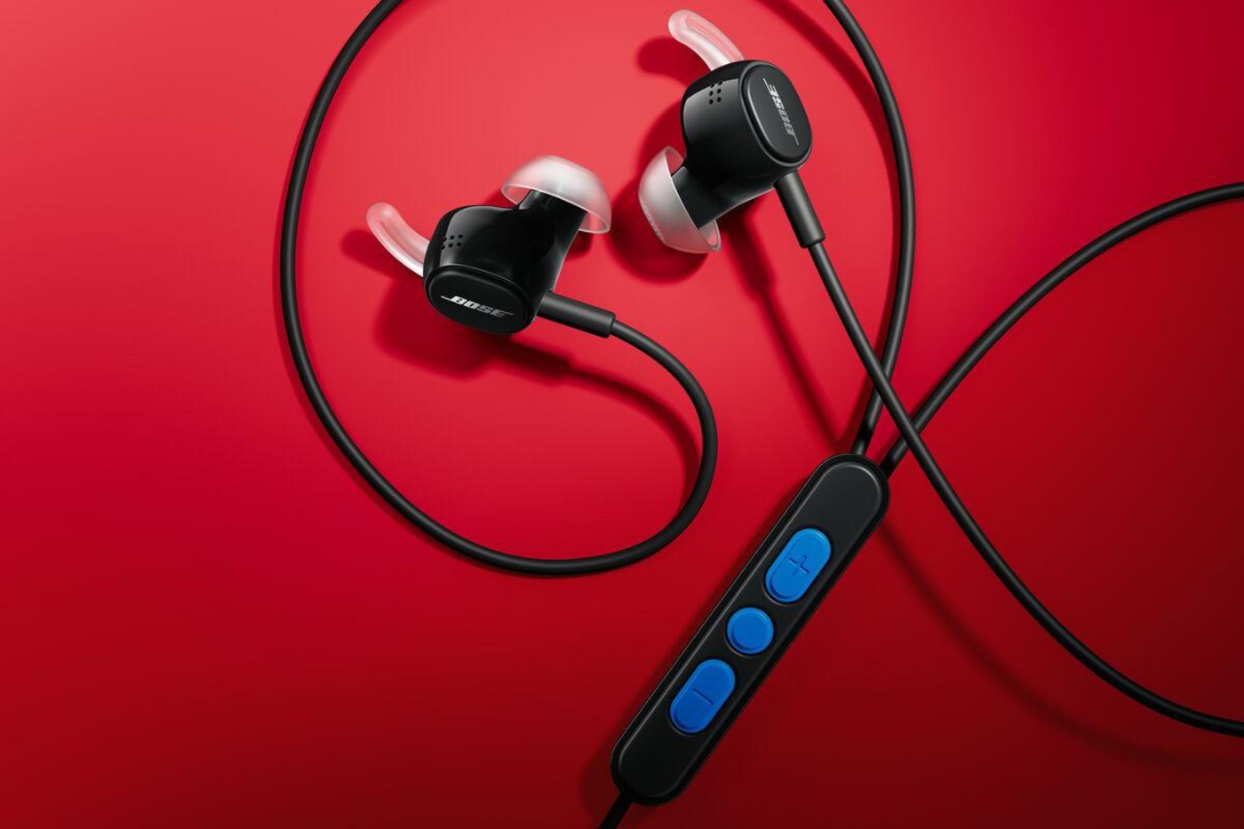 Black buds with the bold blue in-line remote on a red studio set