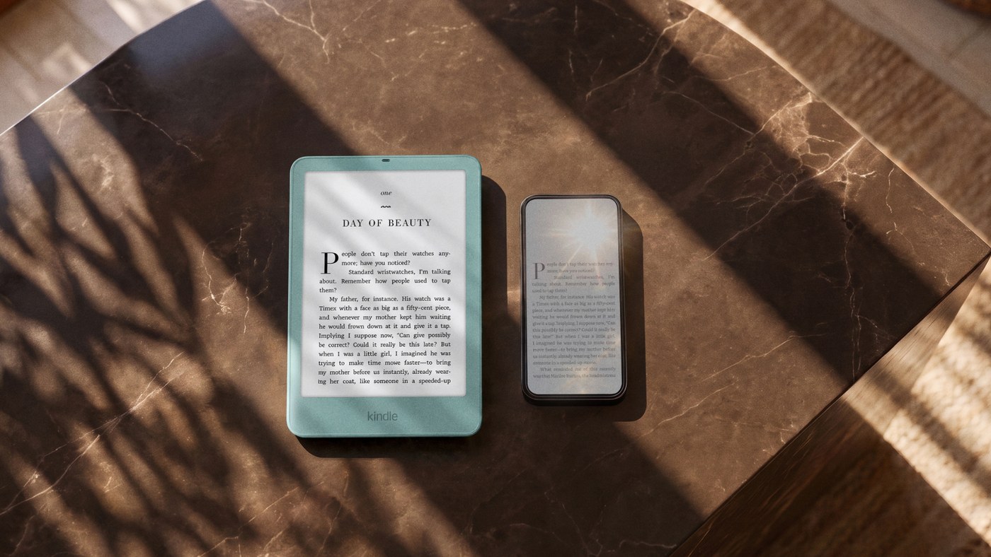 New 6-inch Kindle in Seaglass Green beside a smartphone on a table, showing its pocket size