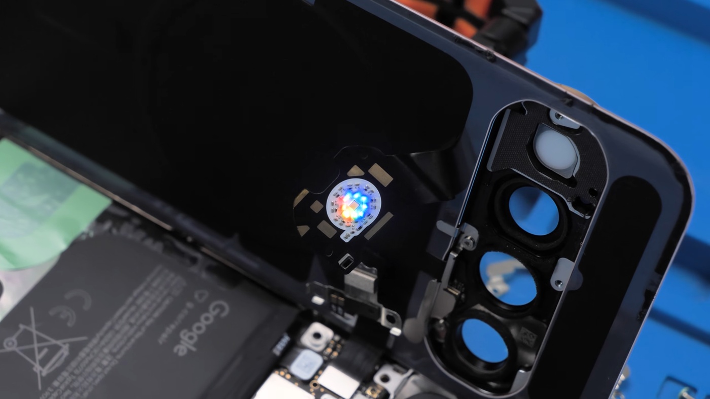 With the back glass lifted, the eight LEDs glow around the flash