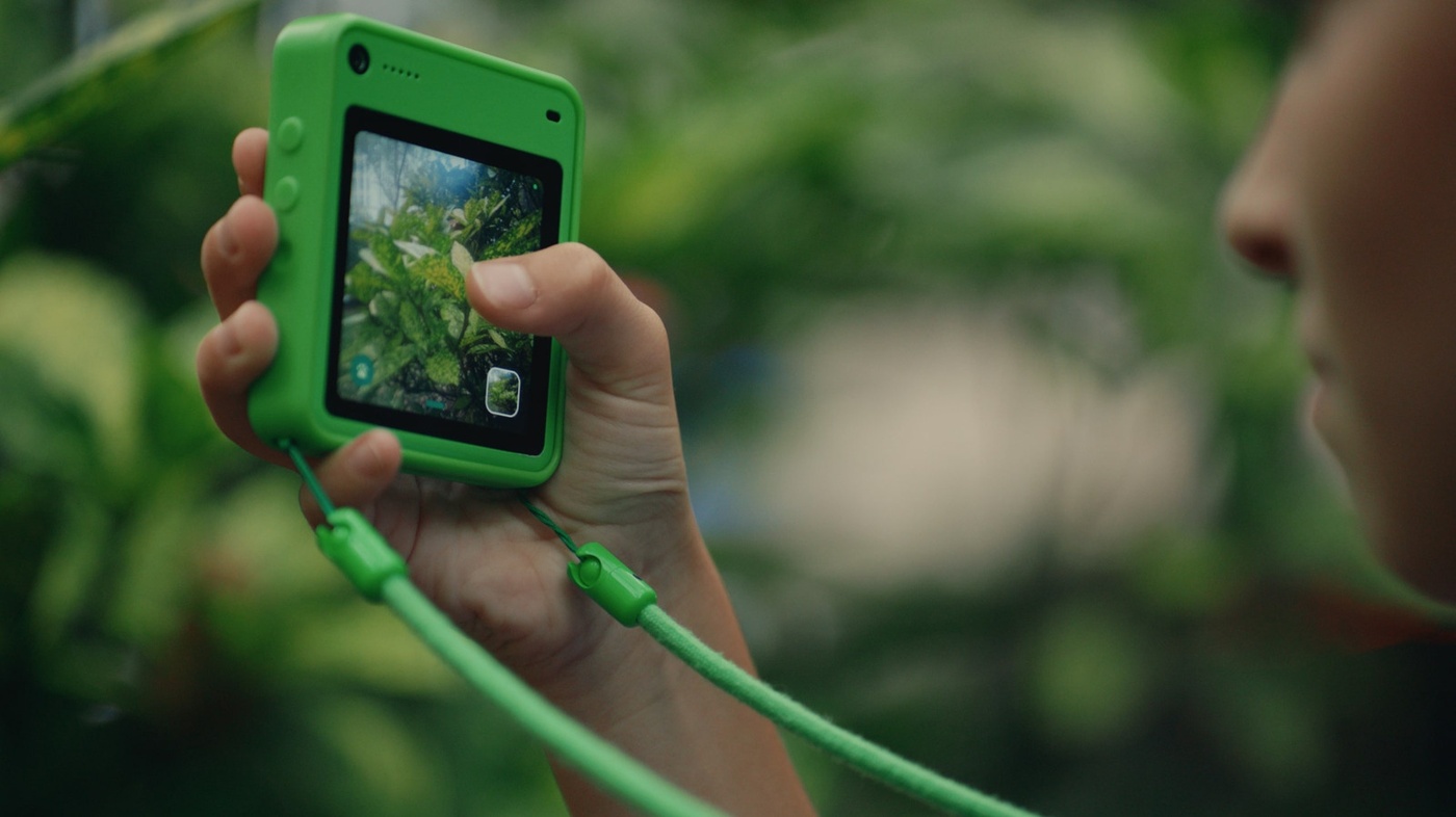 Close-up outdoor Discovery Camera use with foliage background