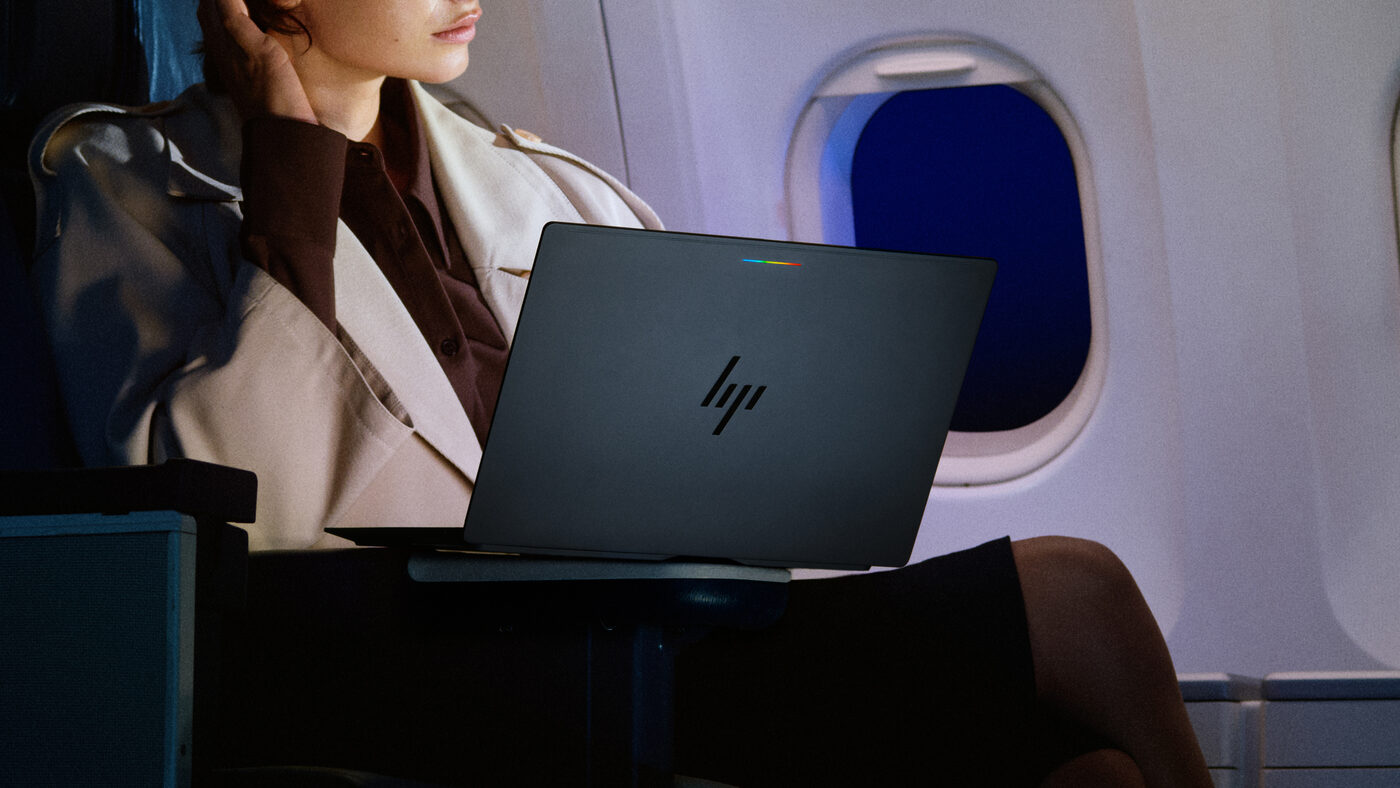 Traveler using an HP Googlebook with Glowbar on an airplane tray table