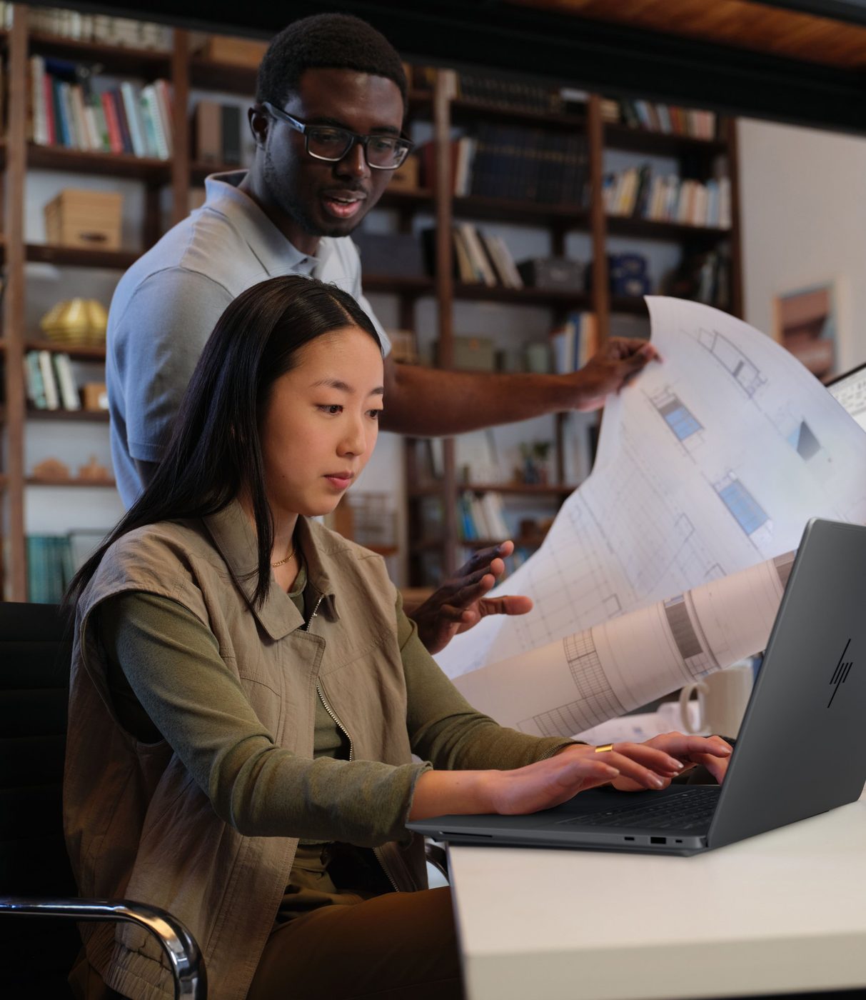 Close view of the HP ZBook Ultra G3a in use as colleagues review architectural drawings