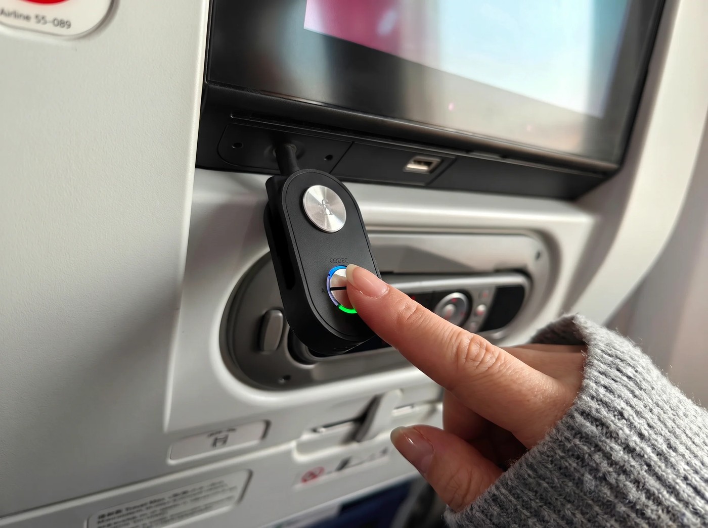 The UP Travel Max plugged into an airplane seat-back entertainment system.