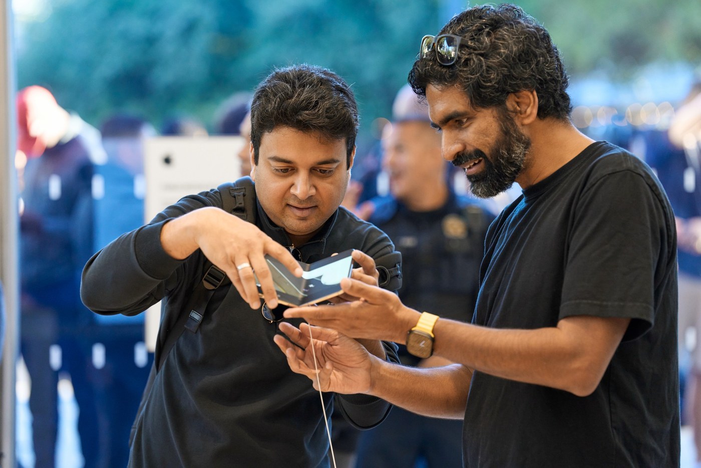 Customers try the iPhone Duo hinge at Apple Domain Northside.