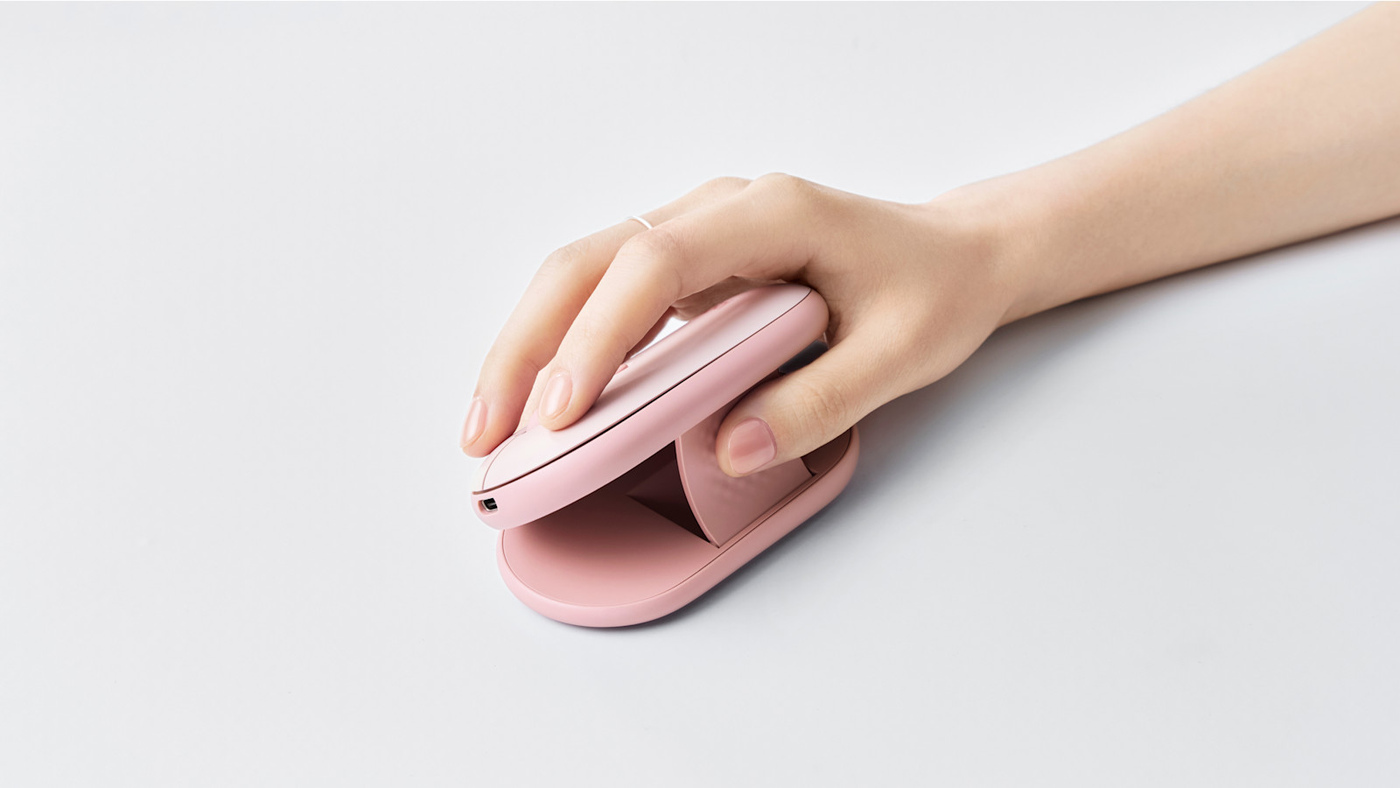 The Logitech Pebble Up in Rose, with its shell raised.