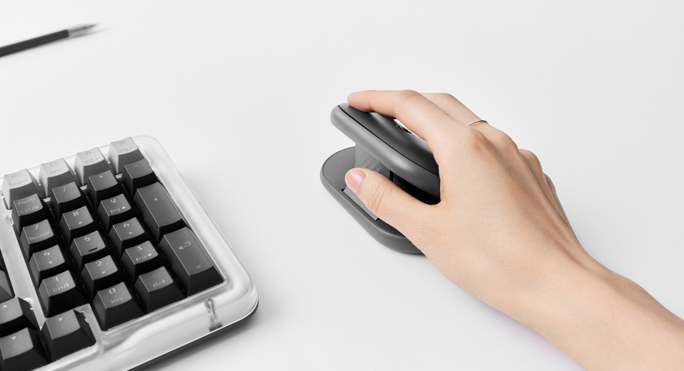 The Pebble Up in Graphite next to a keyboard.
