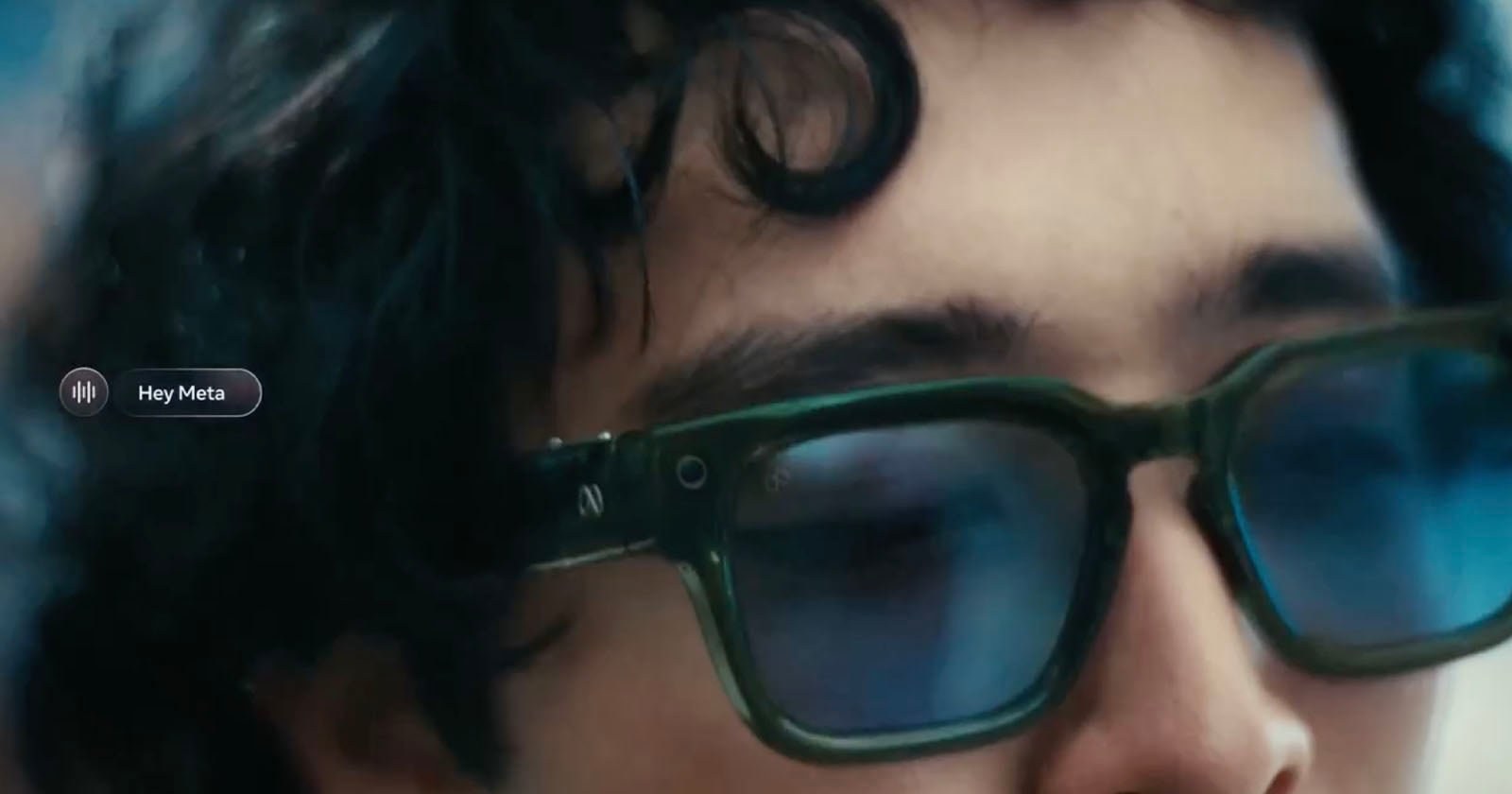 A wearer in Meta glasses with a Hey Meta voice overlay