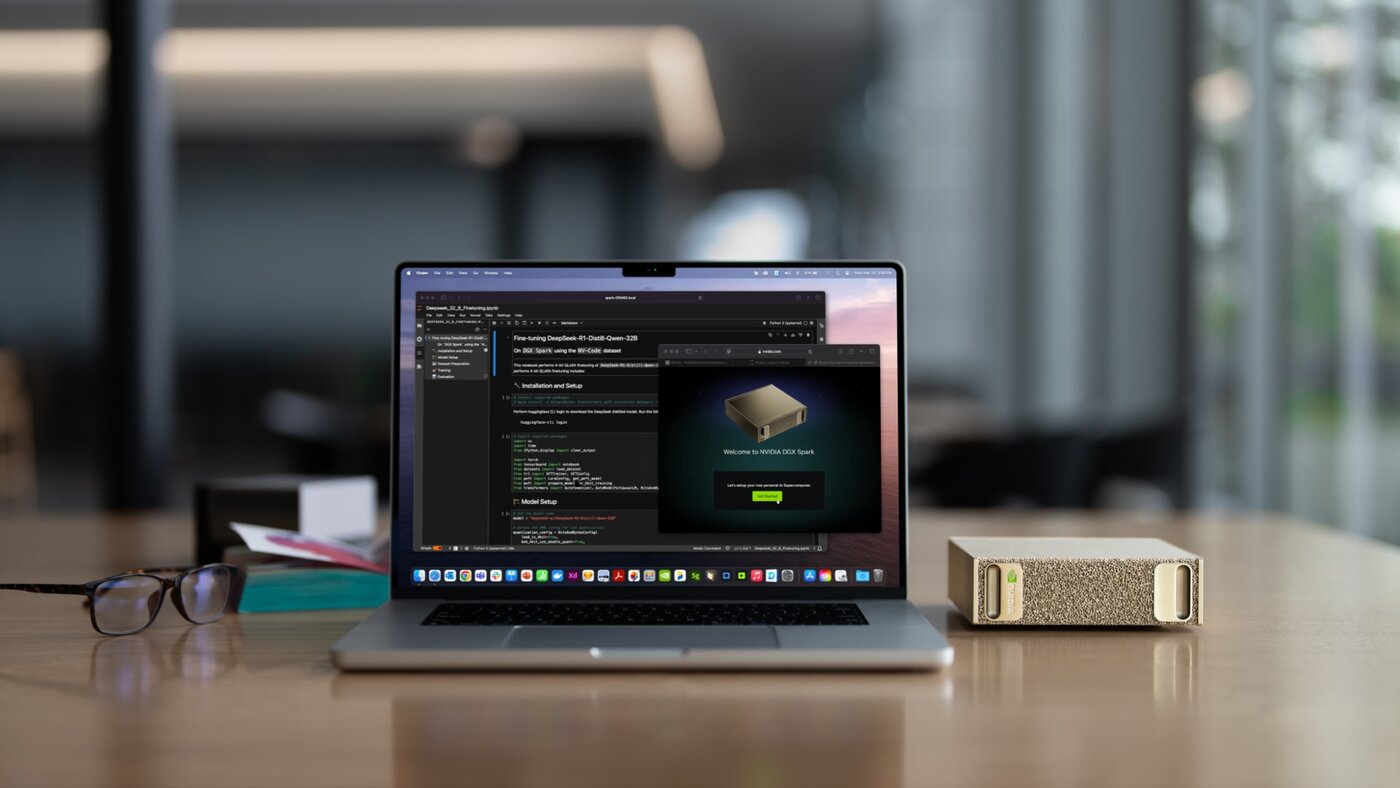 Laptop beside a gold DGX Spark desktop on a wooden desk