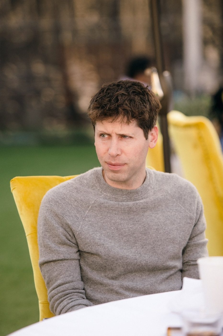 OpenAI chief executive Sam Altman seated outdoors