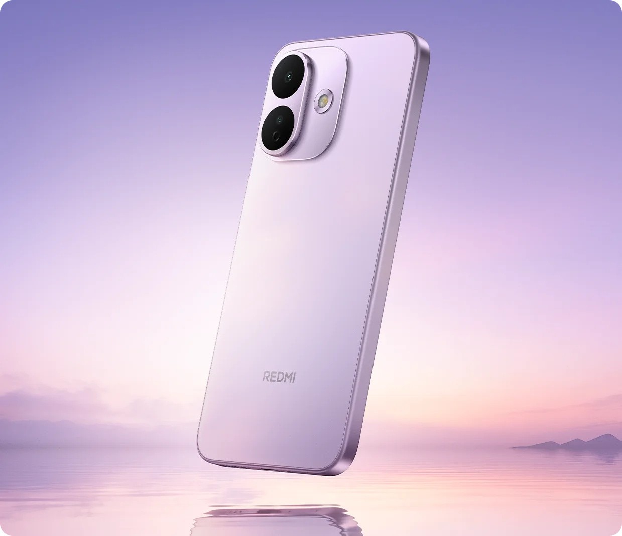 Redmi phone in purple, rear cameras over a sunset water backdrop