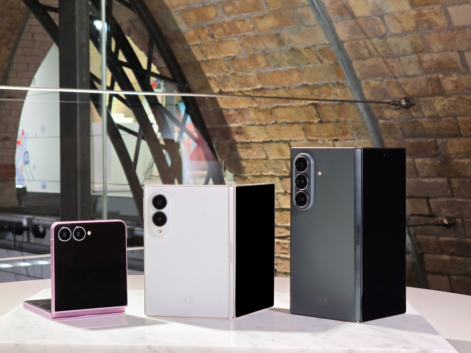Galaxy Z Flip 8, Galaxy Z Fold 8 Ultra, and Galaxy Z Fold 8 standing on a marble table