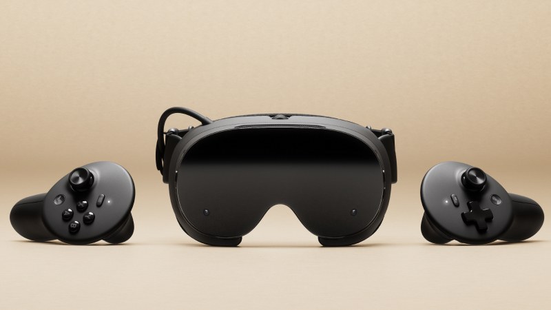 Steam Frame headset and controllers on a beige backdrop