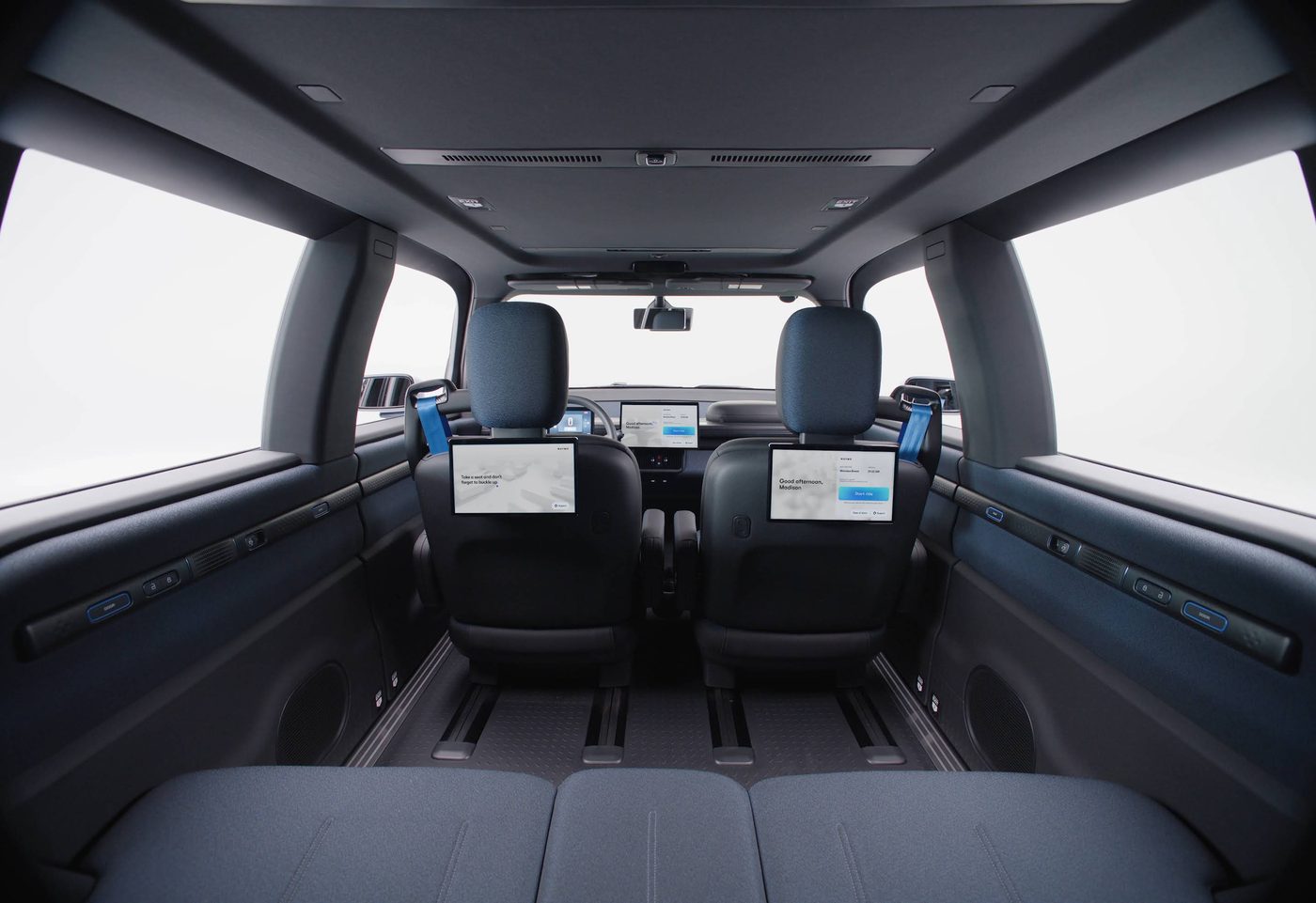 Interior of the Waymo Ojai robotaxi with rear-seat screens